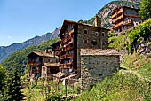 Val Bregaglia - Savogno. Le caratteristiche abitazioni in pietra, alte con lunghi e stretti loggiati in legno che coprono l'intera facciata.